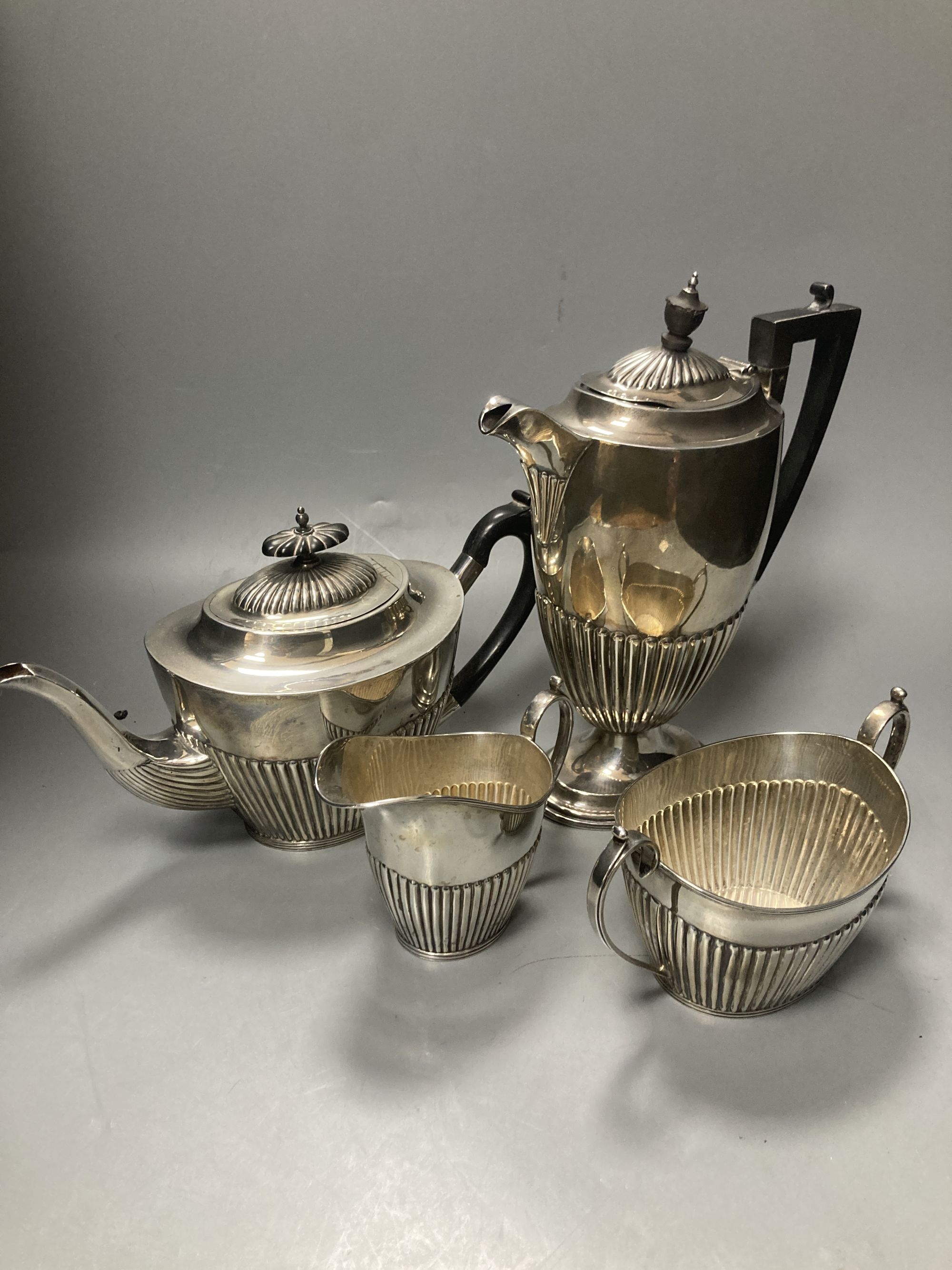 A late Victorian demi fluted silver three piece tea set, Mappin & Webb, Sheffield, 1897 & a matched hot water pot,